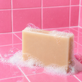 Sea Moss Soap Bar with bubbles on a pink tiled bathroom counter. Sea Moss Soap b BE So Selfish